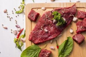 Raw beef on white wood background photo