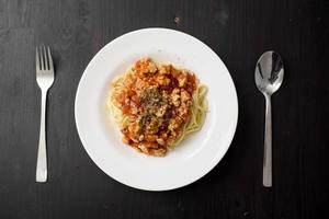 Spaghetti on black wooden background photo