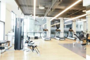 Abstract blur fitness equipment in gym room interior photo