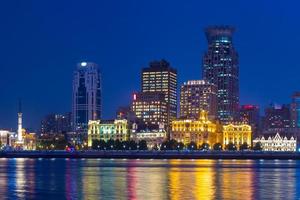 Night view of Shanghai by Huangpu river in China photo