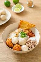 Spicy small flat rice noodles with fish balls and shrimp balls without soup - Asian food style photo