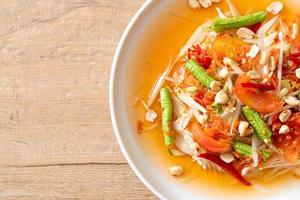 Papaya spicy salad - somtam - Thai traditional street food style photo