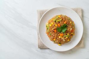 arroz frito con guisantes, zanahoria y maíz - estilo de comida vegetariana y saludable foto