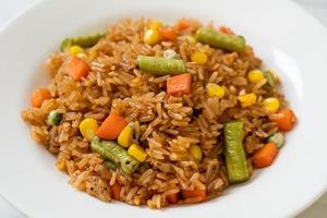 Fried rice with green peas, carrot and corn - vegetarian and healthy food style photo