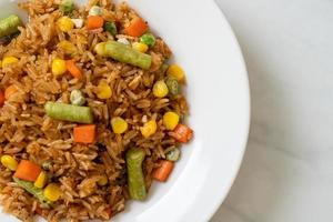 Fried rice with green peas, carrot and corn - vegetarian and healthy food style photo