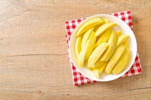 Fresh green and golden mango sliced on plate photo