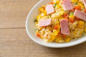 Homemade fried rice with ham and mixed vegetable of carrot and green bean peas photo