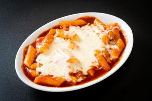 Korean rice cake in spicy Korean sauce with cheese  or Cheese Tokpokki or Tteokbokki with Cheese