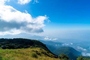 Beautiful mountain layer with clouds and blue sky at Kew Mae Pan Nature Trail in Chiang Mai, Thailand photo