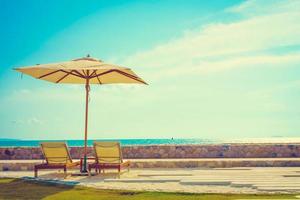 Umbrella and chair with sea view photo