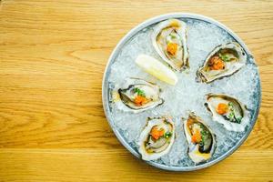 Raw and fresh oyster shell with lemon photo