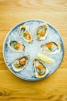 Raw and fresh oyster shell with lemon photo