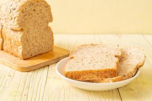 Sliced wholegrain bread on a wooden table photo