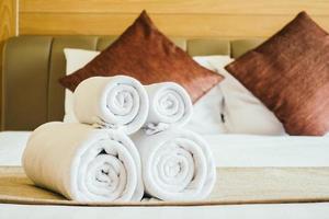 White bath towel on bed photo