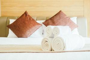 White bath towel on bed
