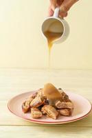 Grilled bananas with coconut caramel sauce on plate photo