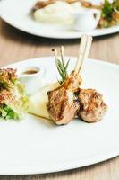 Grilled rack of lamb meat with sauce photo