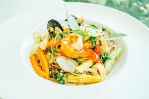 Spicy seafood spaghetti or pasta in white plate photo