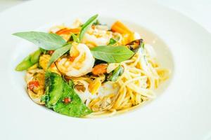 Spicy seafood spaghetti or pasta in white plate photo