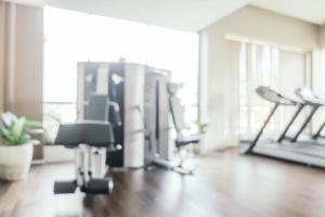 Abstract blur fitness equipment in gym room interior photo