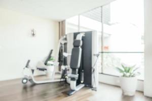 Abstract blur fitness equipment in gym room interior photo