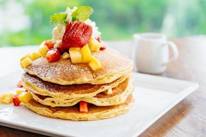 Stack of pancake with strawberry on top photo