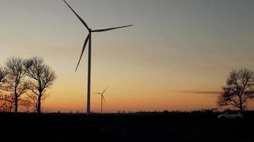 Wind power plants at sunset video