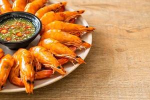 Baked salted shrimps or prawns with seafood spicy sauce - seafood style