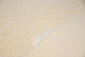 Beautiful soft wave on sand at the sea sunny day photo