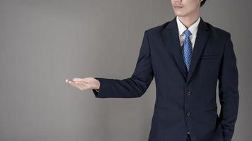 Close up Business man is holding something , grey background in studio photo