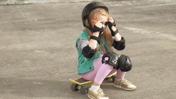 Little girl dresses protection helmet knee pads and elbow pads Sunset video