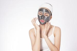 Beautiful woman masking her face on white background photo