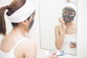 Beautiful woman masking her face on white background photo