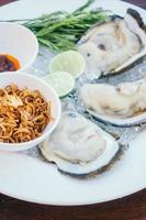 Oyster shell with spicy sauce photo