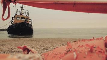 Old wreck near the shore. longboat at the pier video