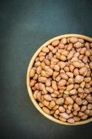 Peanuts in wooden bowl photo