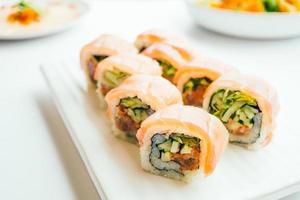 Raw fresh sushi roll with wasabi in white plate photo