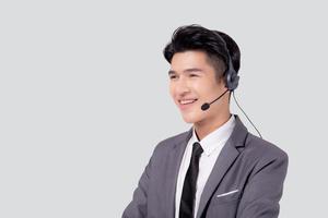 Portrait young asian business man call center wearing headset isolated on white background, agent with support and service, businessman is assistant for client with phone or helpline online. photo