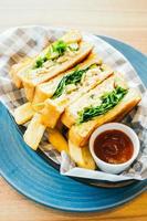 Sandwich with avocado and chicken meat with french fries photo