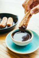 Sweet fried Churros donut with chocolate sauce photo