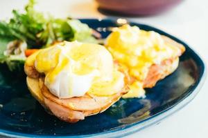 Eggs benedict with ham and sauce on top photo