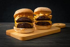 hamburguesas o hamburguesas de ternera con queso y papas fritas - estilo de comida poco saludable foto