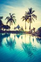 Silhouette coconut palm tree around swimming pool photo