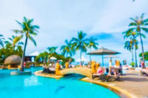 Abstract blur coconut palm tree around swimming pool photo