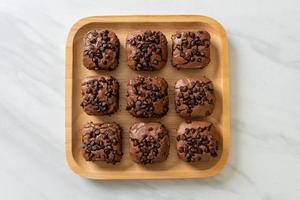 Dark chocolate brownies with chocolate chips on top photo