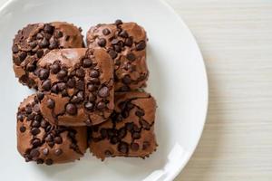 Dark chocolate brownies with chocolate chips on top photo