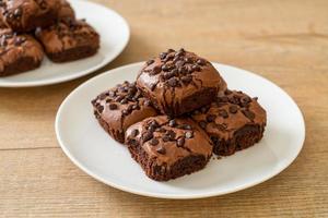 Dark chocolate brownies with chocolate chips on top photo