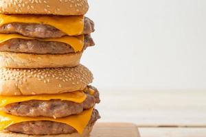 Pork hamburger or pork burger with cheese on wooden board photo