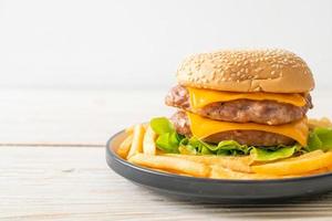 Pork hamburger or pork burger with cheese and french fries photo