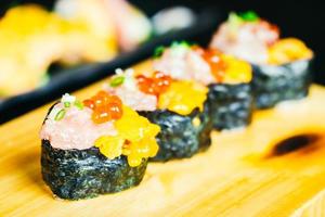 Uni sushi with otoro tuna and salmon egg on top photo